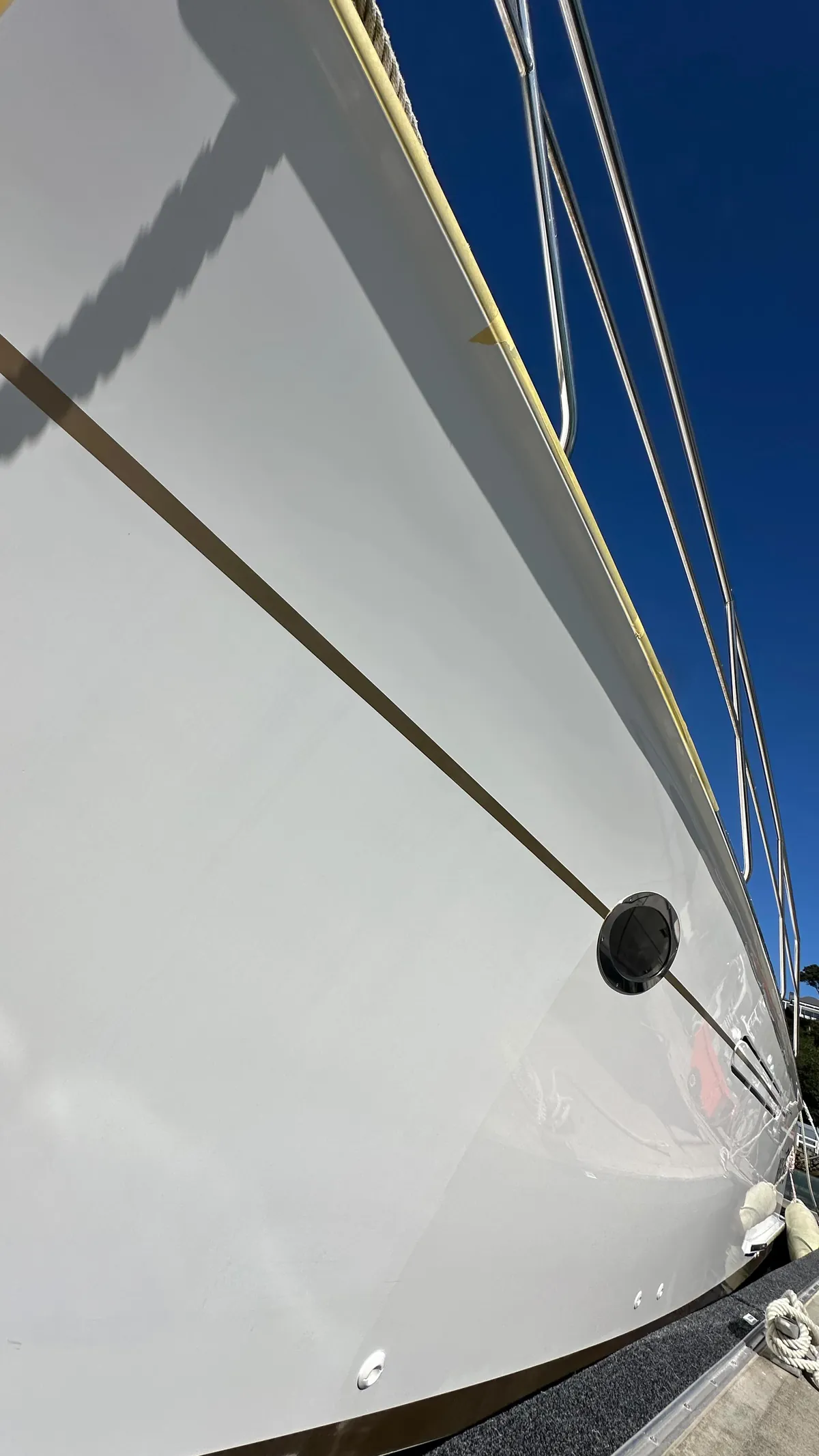 White boat hull reflecting like glass after a machine cut and polish