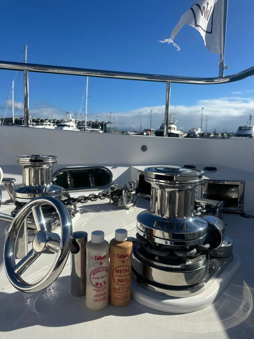 Polished stainless winches, rails and brightwork on a boat foredeck — Warkworth