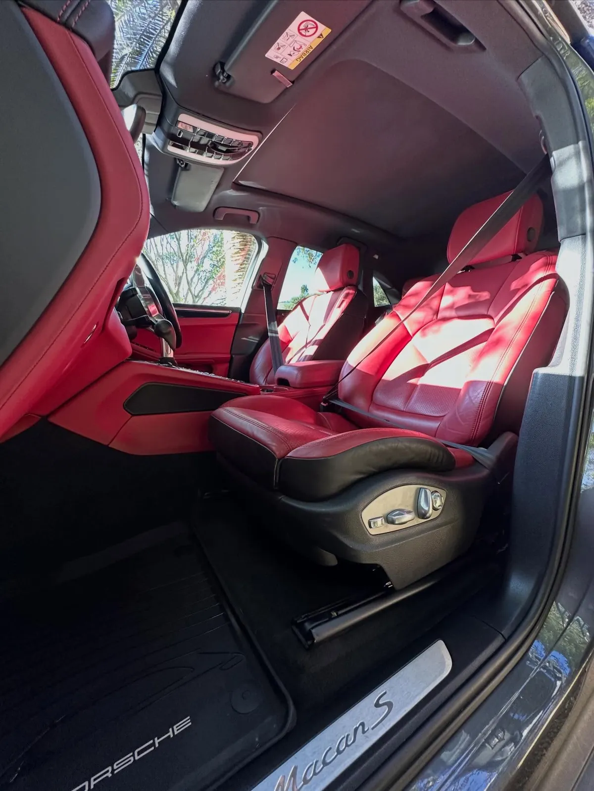 Red leather Porsche interior after deep clean and protection