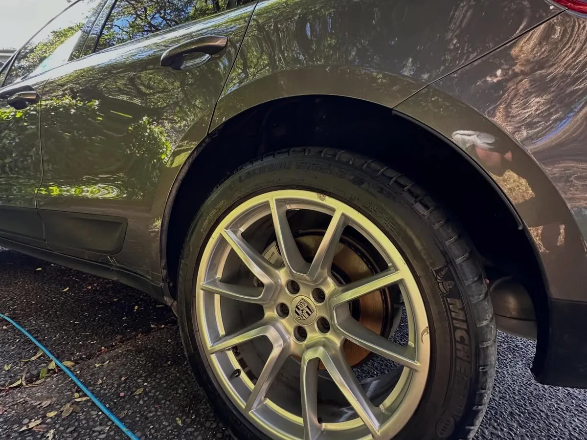 Porsche Macan alloy wheel after decontamination and detail — brake dust gone, finish restored