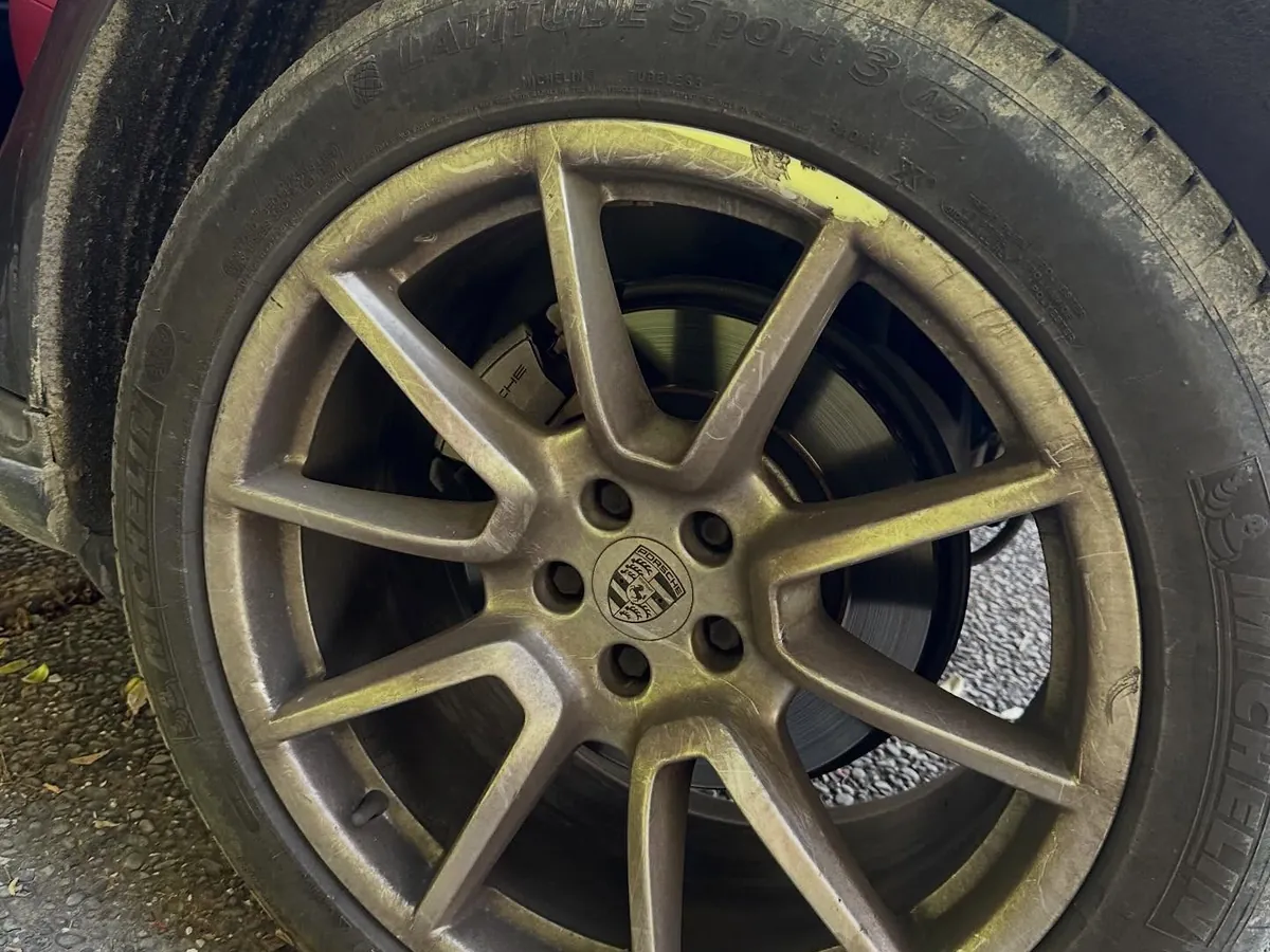 Porsche Macan alloy wheel before detailing — caked in brake dust and grime